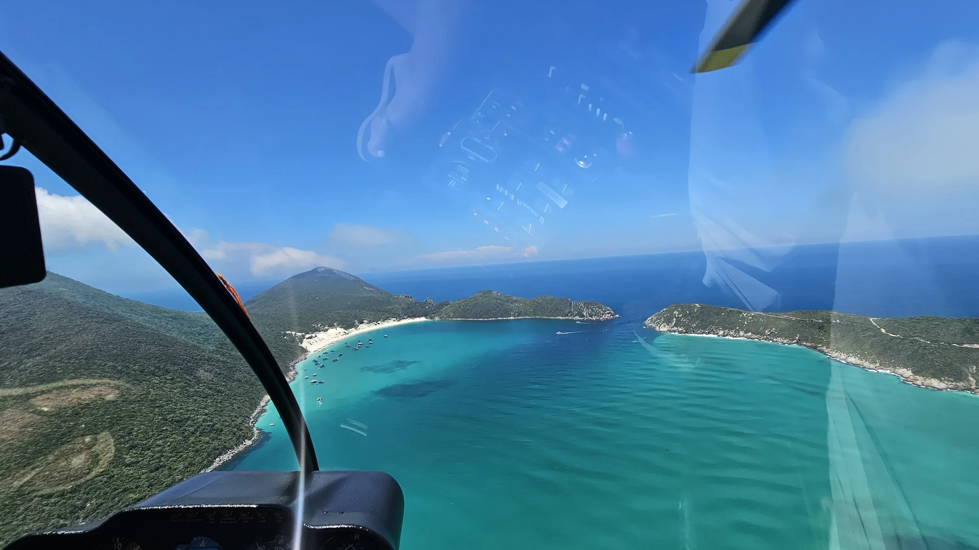 Helicóptero sobrevoando a costa de Búzios com o mar ao fundo